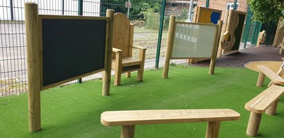Playground equipment including white board and seating