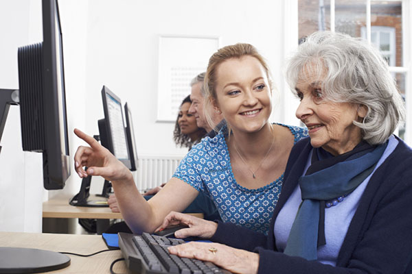 lady being taught computer skills