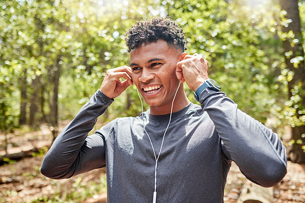 Man wearing headphones while running