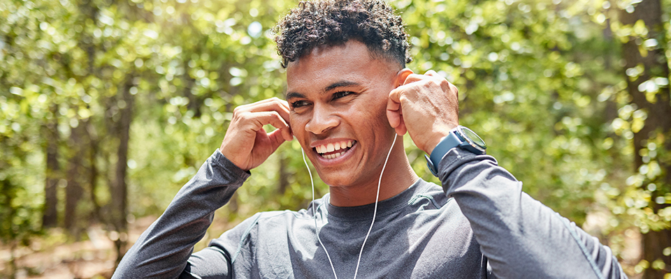 Man with headphones in the park walking 