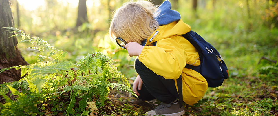 Child with magnifying glass