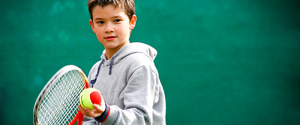 Boy playing tennis