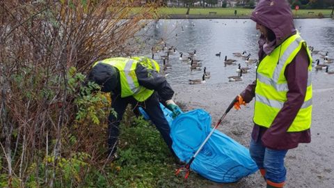 local people litter picking in a Redbridge park