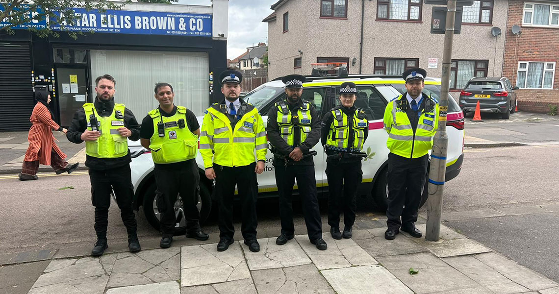 Council enforcement officers and police officers lined up on street in uniform