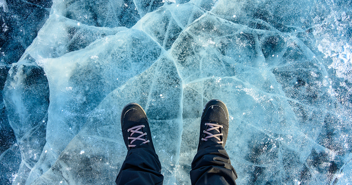 Person standing on frozen water