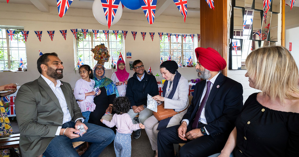 Leader and Deputy Leader sat inside community hall