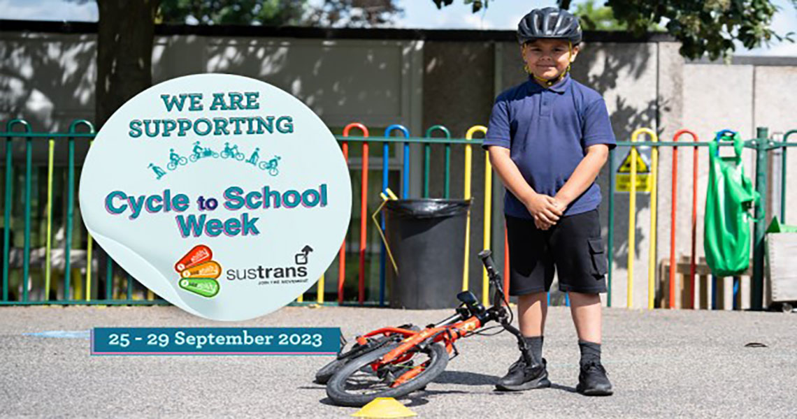 child by bike with cycle to school info next to him
