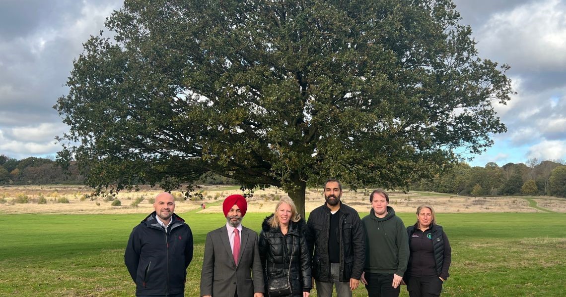 Cllrs and Council Officers stood in front of tree