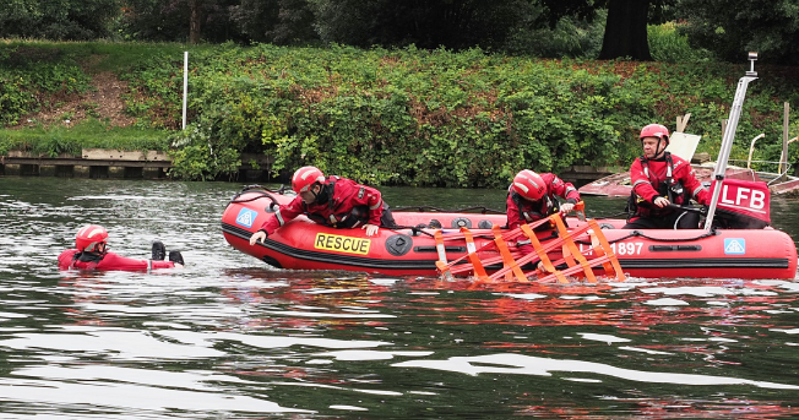 A group of people enjoying a boat ride on calm water, surrounded by nature.