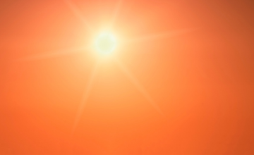  Sunlight illuminates a vibrant orange sky, creating a warm and radiant atmosphere.