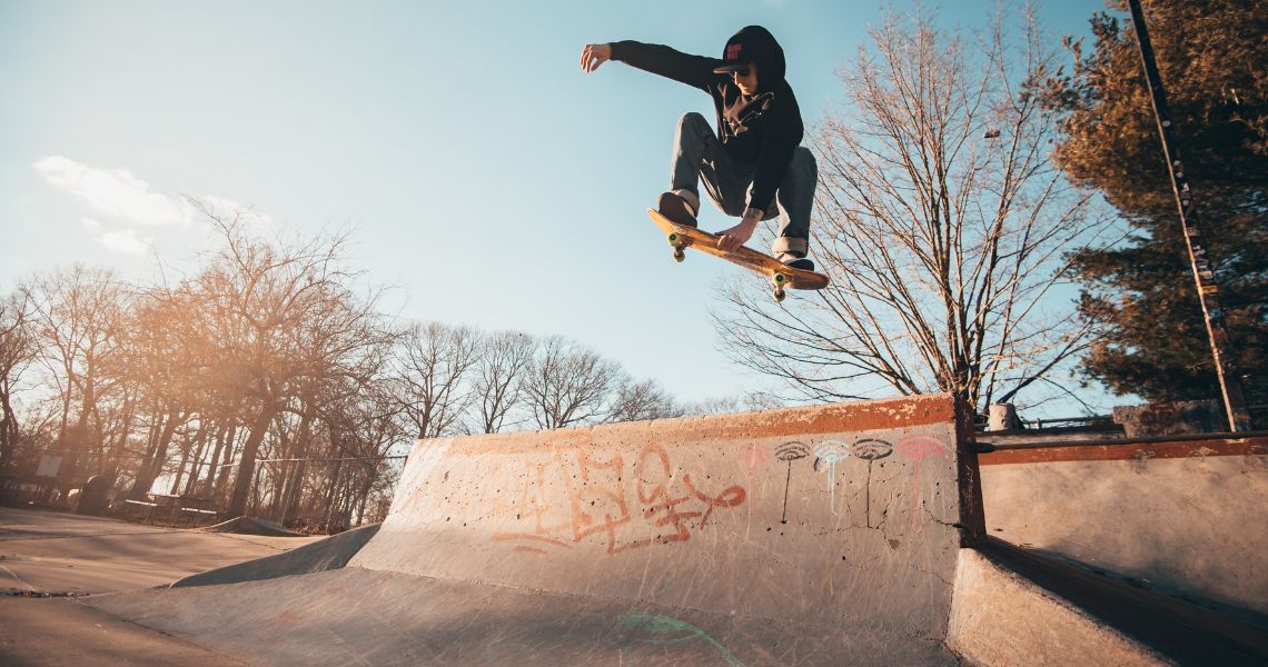 A skateboarder getting totally rad air over a quarter pipe