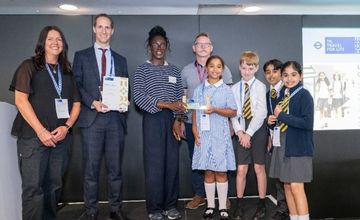 school staff and pupils holding award