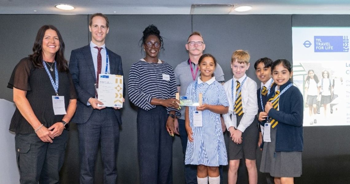 school staff and pupils holding award