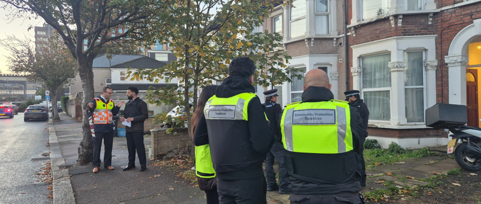 Councillor Sunny Brar, Cabinet Member for Enforcement, Community Safety and Cohesion speaks with Director of Community Safety whilst the Community Protection Taskforce and Met Police action warrants on properties