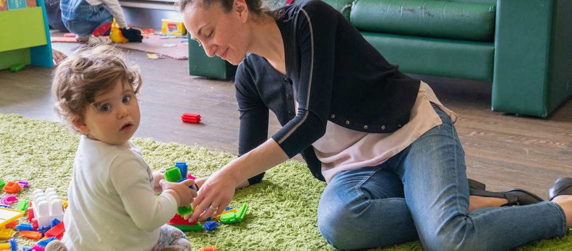 woman and child playing in a library