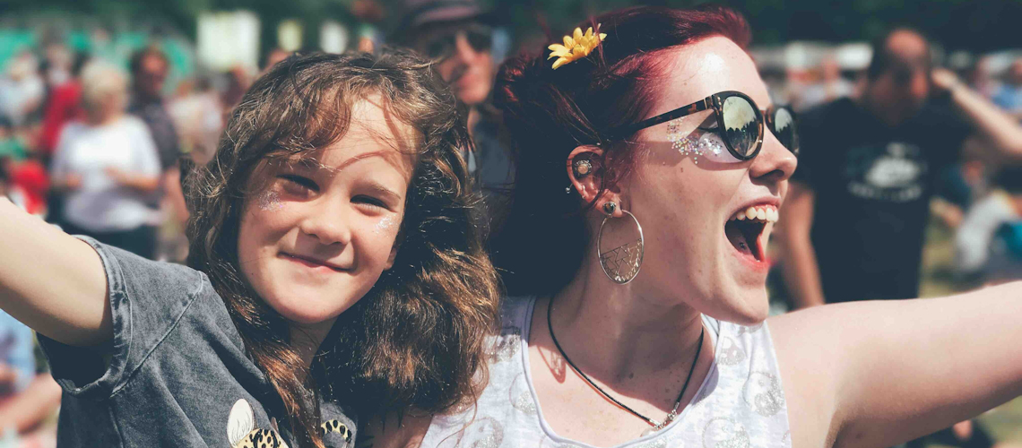 Mother and daughter hugging at a festival