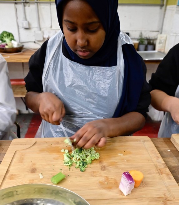 Child chopping vegetables