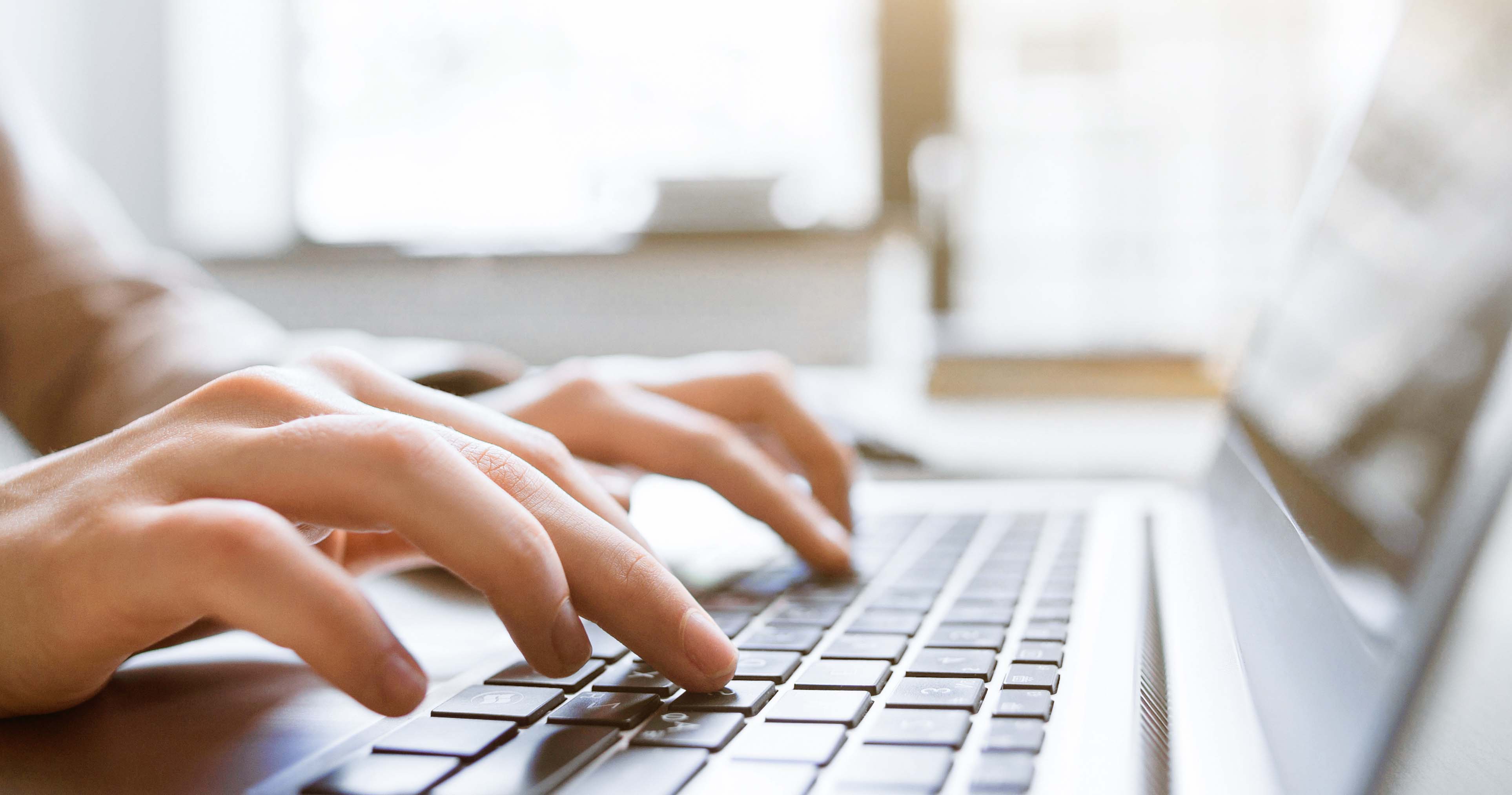 Hands typing on keyboard