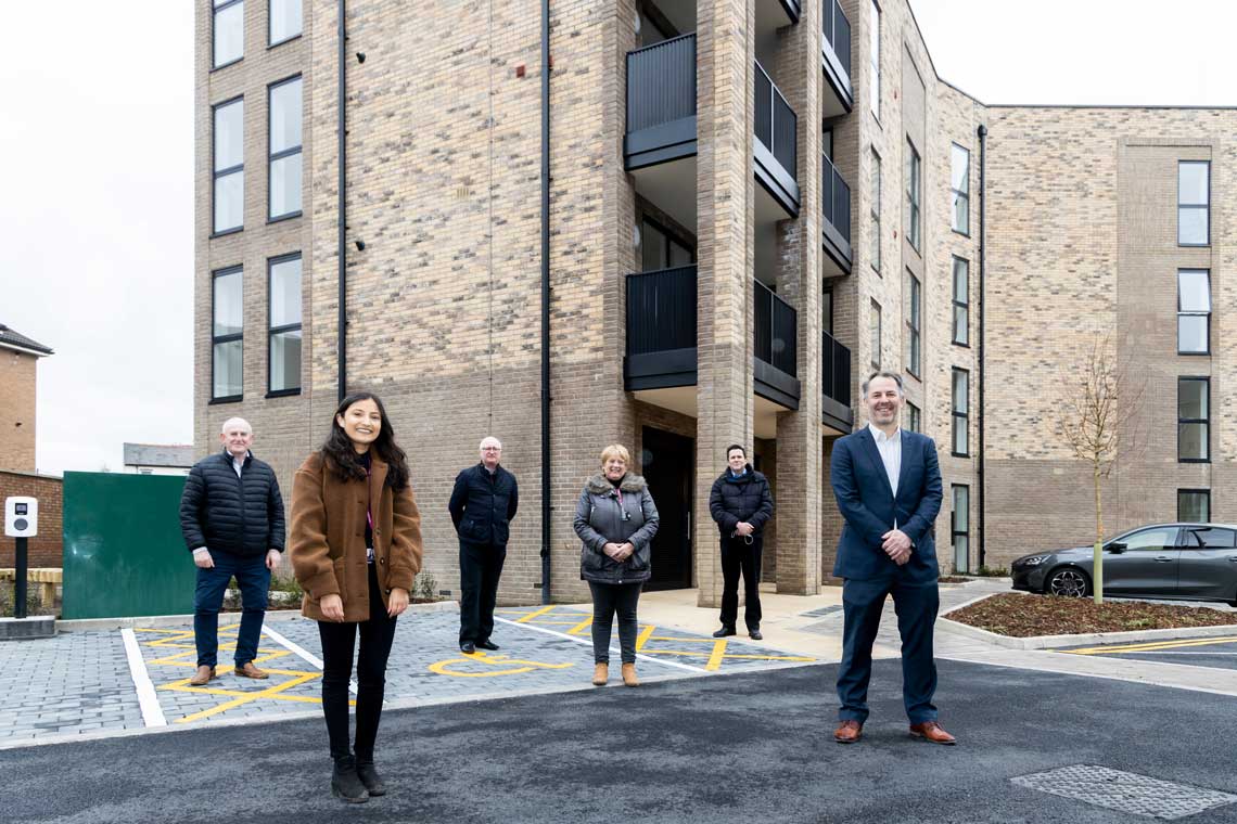 councillors, residents and staff outside block of new council flats