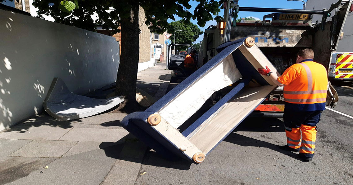 council staff removing fly-tipped sofa