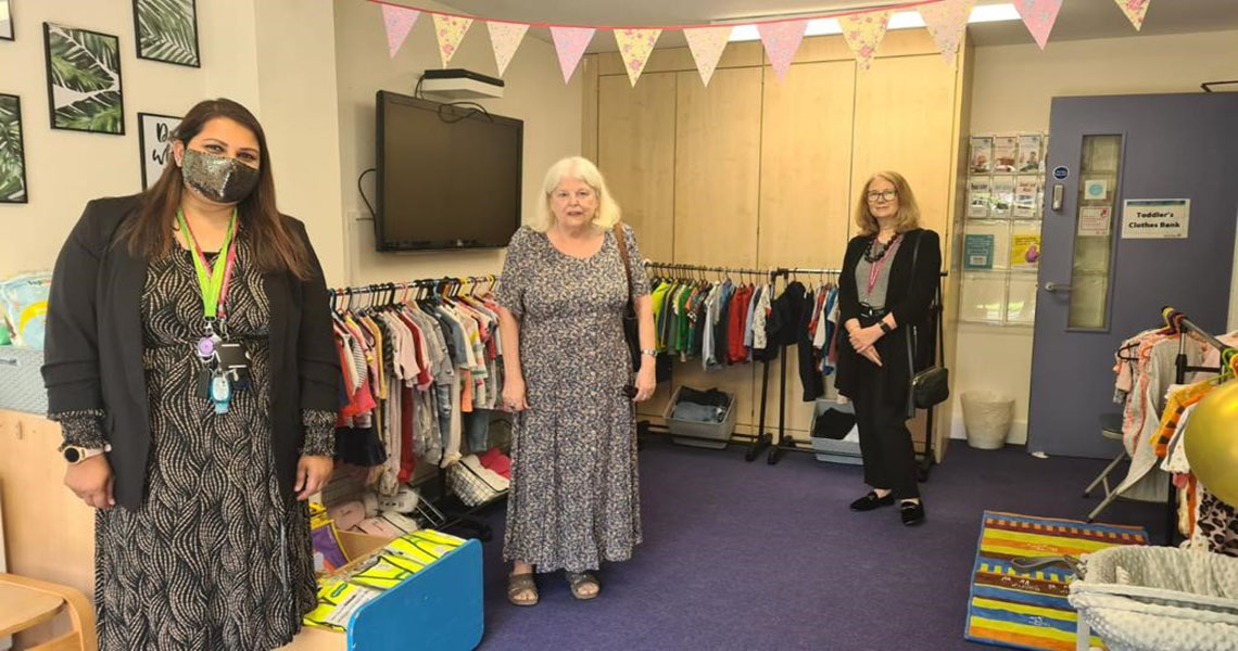 launch of clothes bank with Early Years Manager, Redbridge CEO and Cabinet Member in the shot with clothes rails behind them