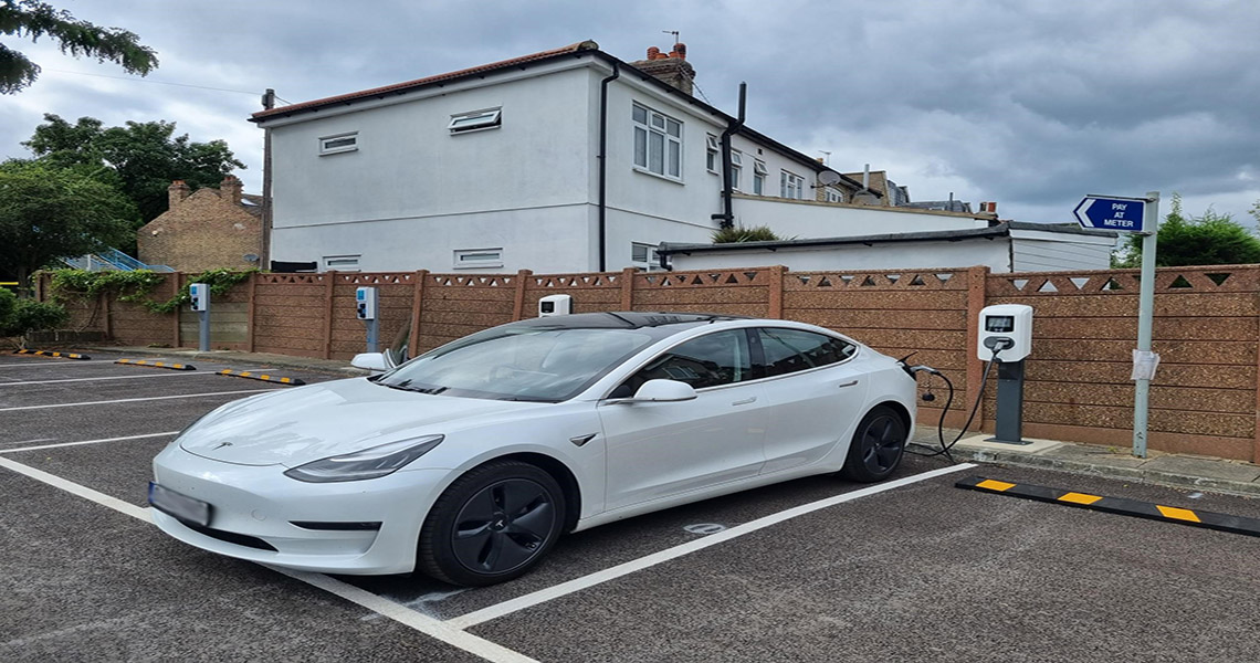 white electric car being charged