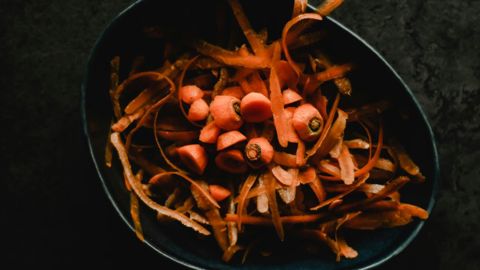 Carrot tops and peelings in a bowl