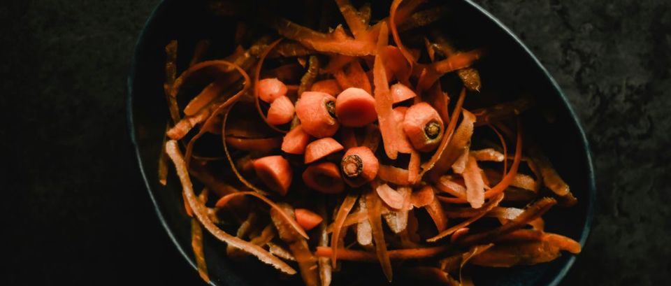 Carrot tops and peelings in a bowl