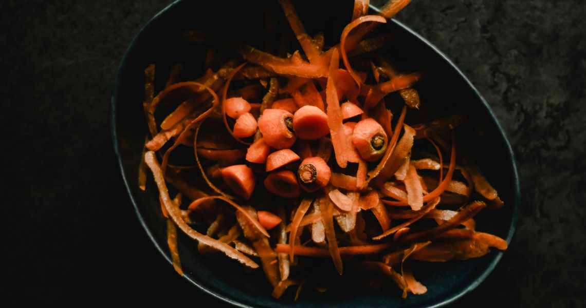 Carrot tops and peelings in a bowl