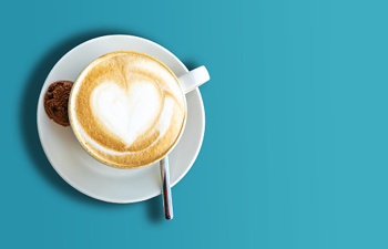 Cup of coffee with heart shaped froth