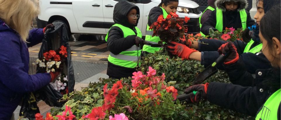 children taking part in community planting day