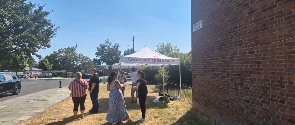Resident engagement officers gather round a tent with the text 'Come and speak to us' to support tenants