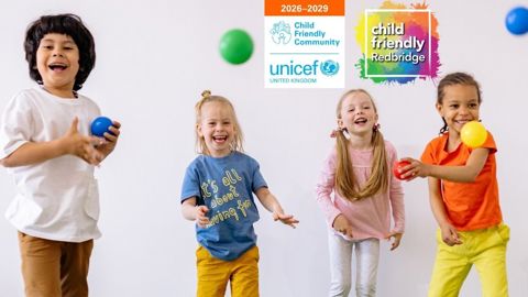 Four young children having fun, throwing coloured balls, with the UNICEF UK and Child Friendly Redbridge logos in the background