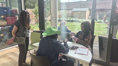 Councillor Saima Ahmed, Cabinet Member for Housing and Homelessness speaks with service users and providers