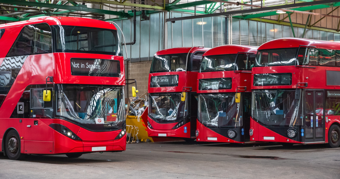 Red double-decker buses in their depot