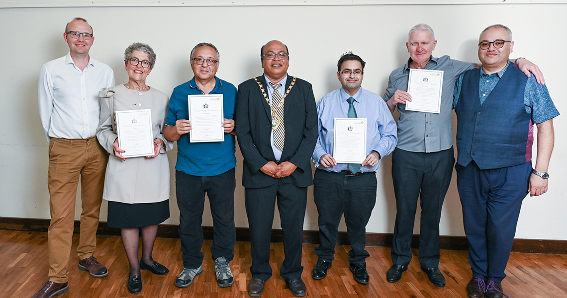 Seven people lined up for photo