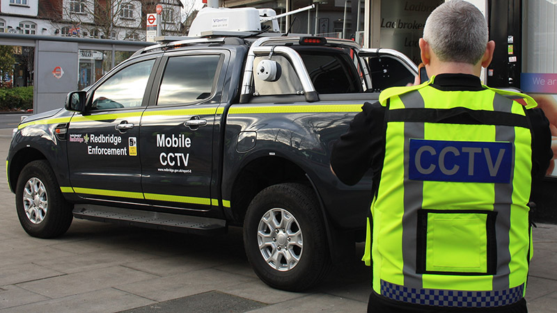 Enforcement officer in front of the Redbridge mobile CCTV vehicle image