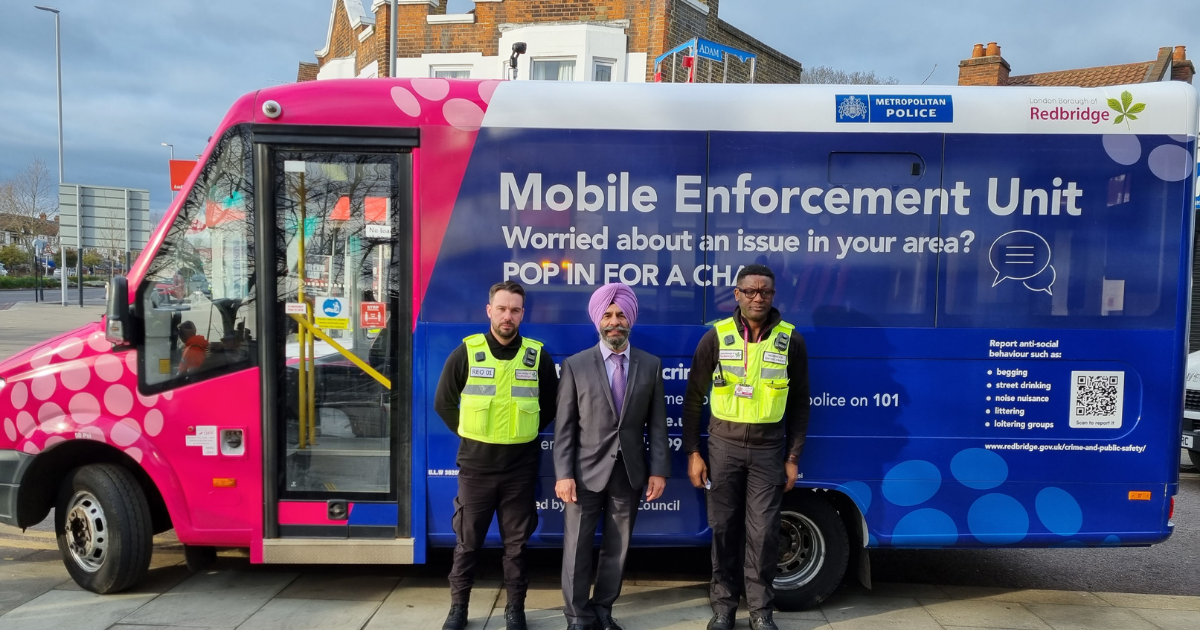 Jas Athwal and two enforcement officers in front of a vehicle enforcement hub